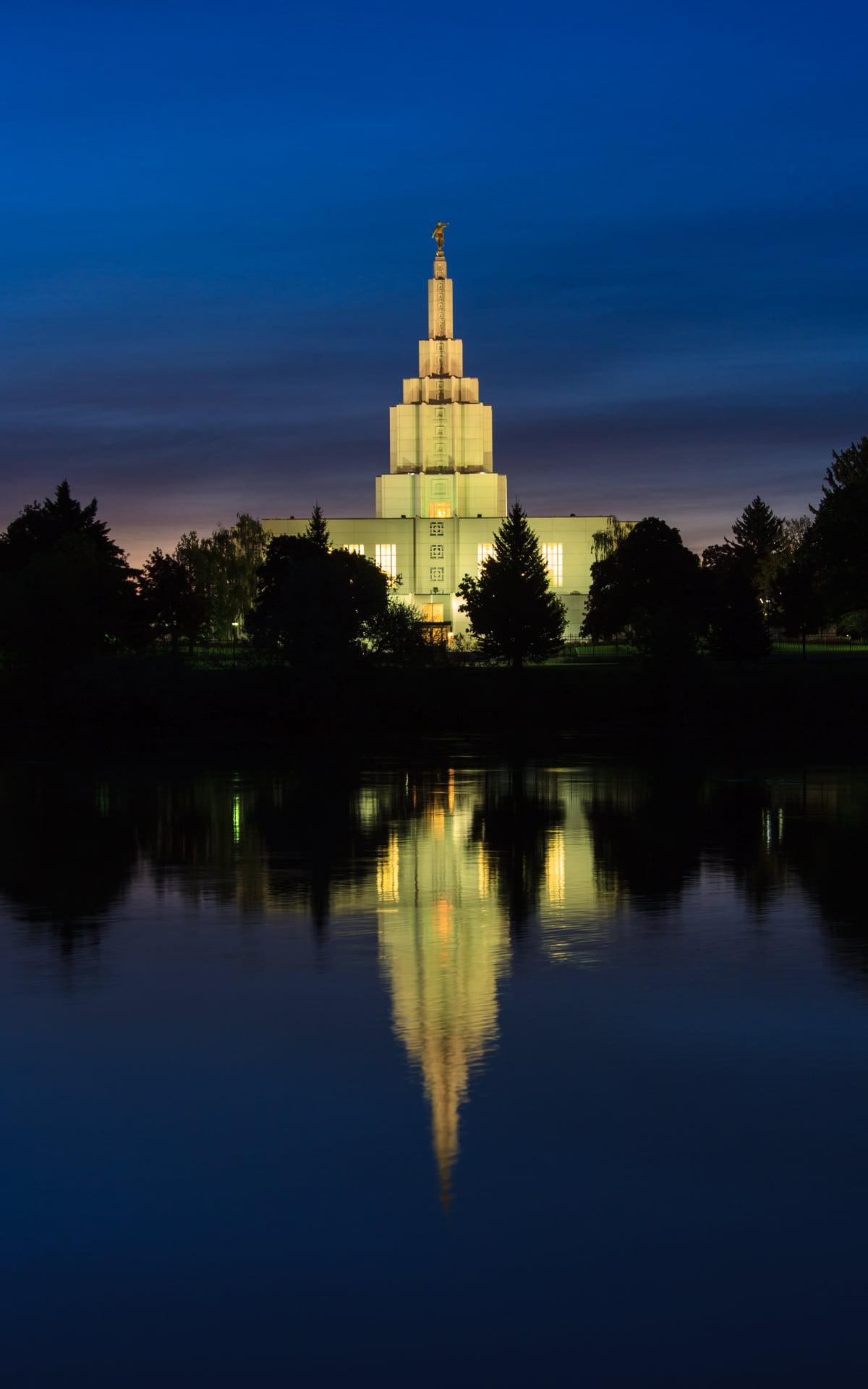 The temple illuminated at night, creating a peaceful scene.