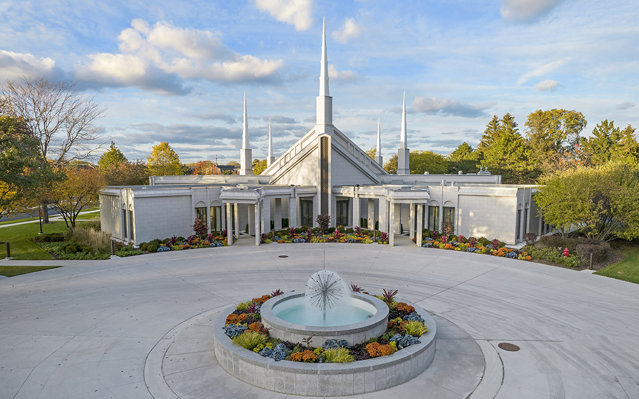 The light gray granite exterior reflecting morning sunlight on the manicured grounds.