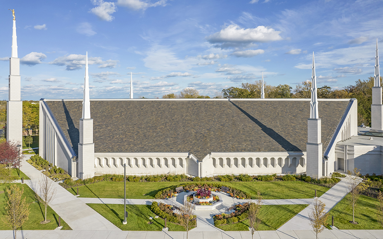 A wide view showing the temple's relationship to the surrounding wooded landscape.
