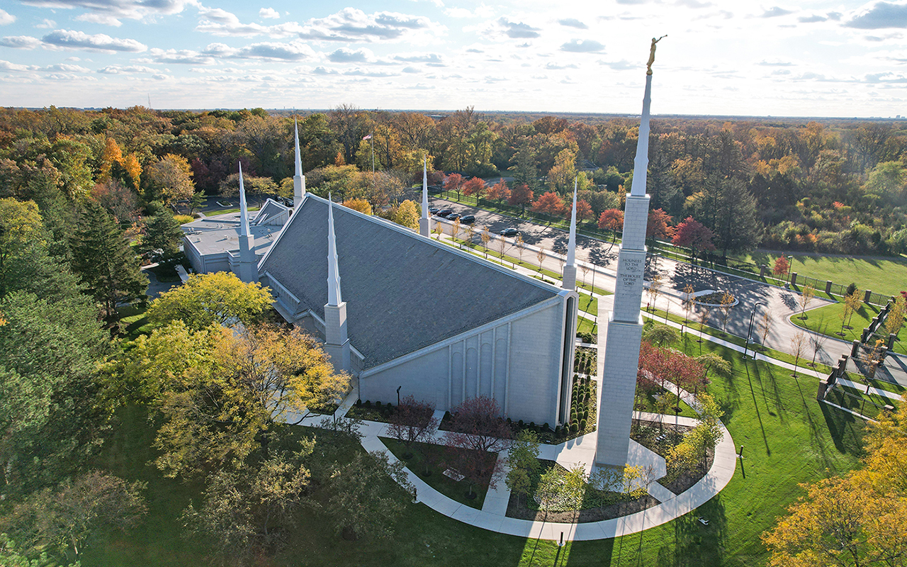 The temple from across the water feature, showcasing reflections of the six spires.