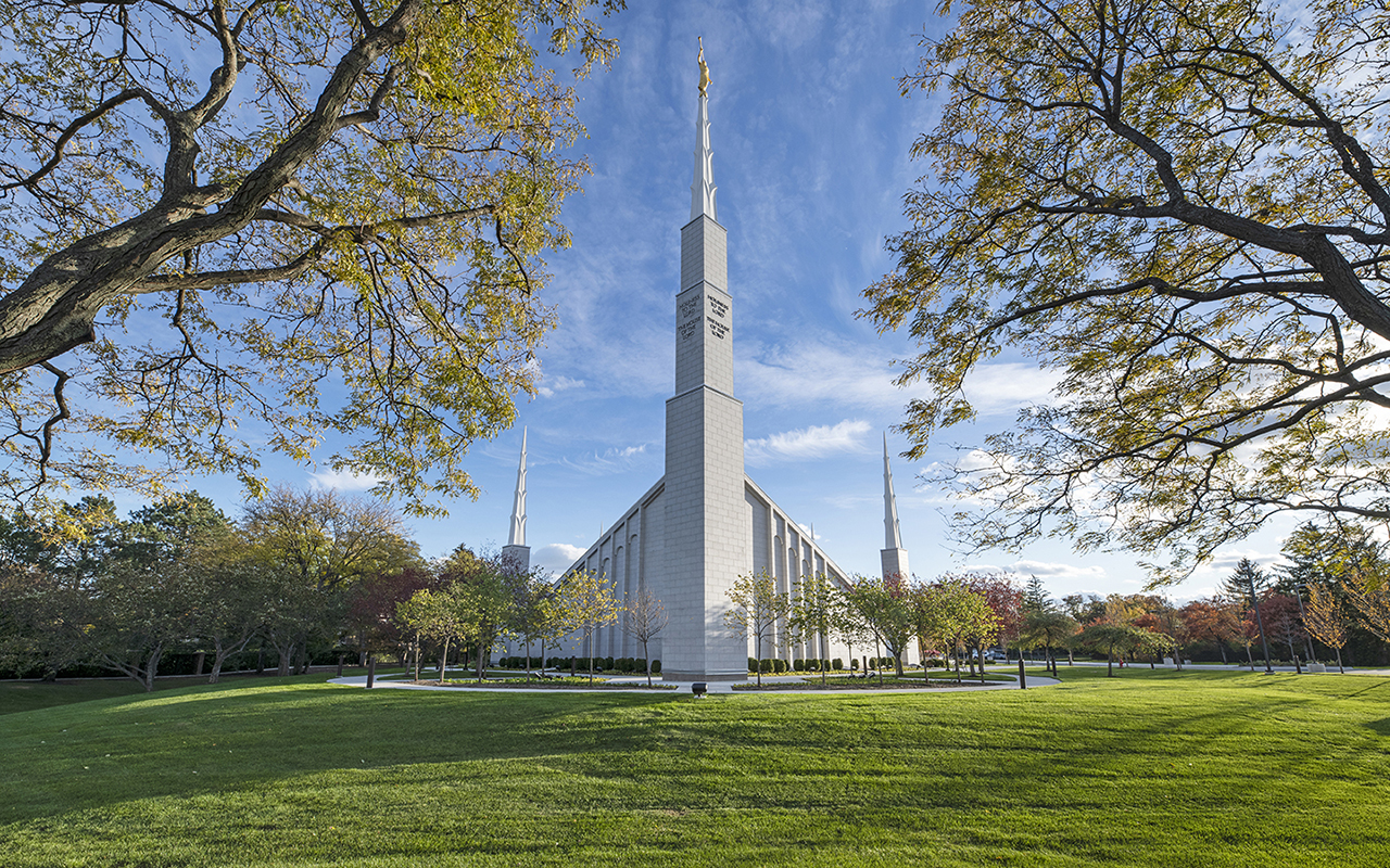 The temple in winter with a light dusting of snow on the grounds and slate roof.