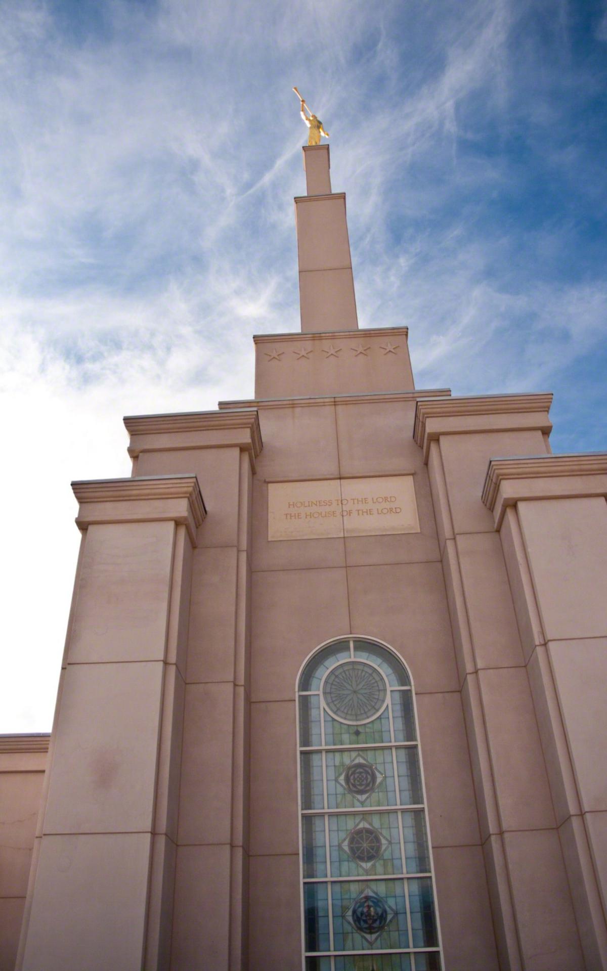 The temple's spire reaches towards the heavens, topped with a gold-leafed statue of the angel Moroni.