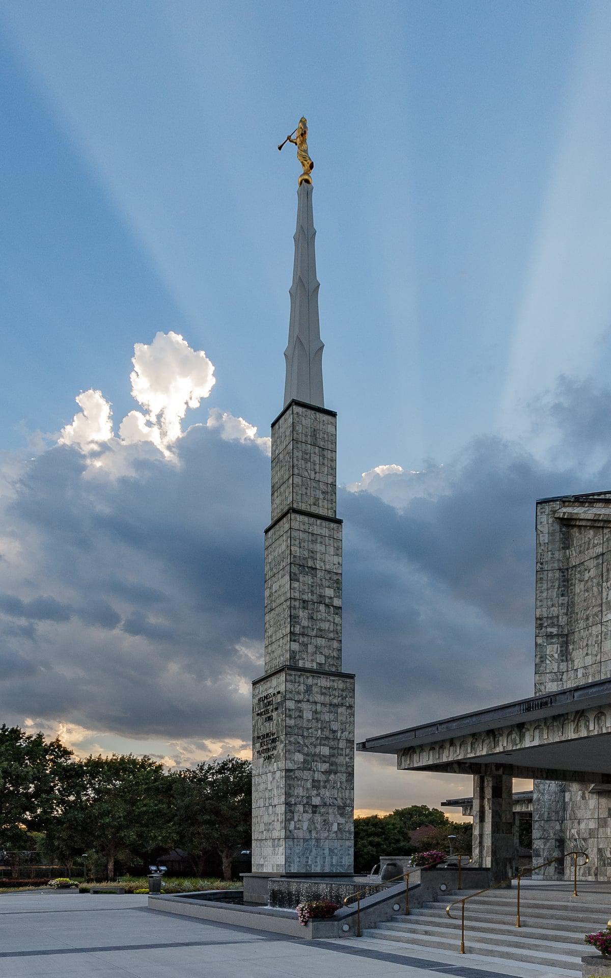 A wide-angle view showing all six spires rising above the North Dallas tree line.