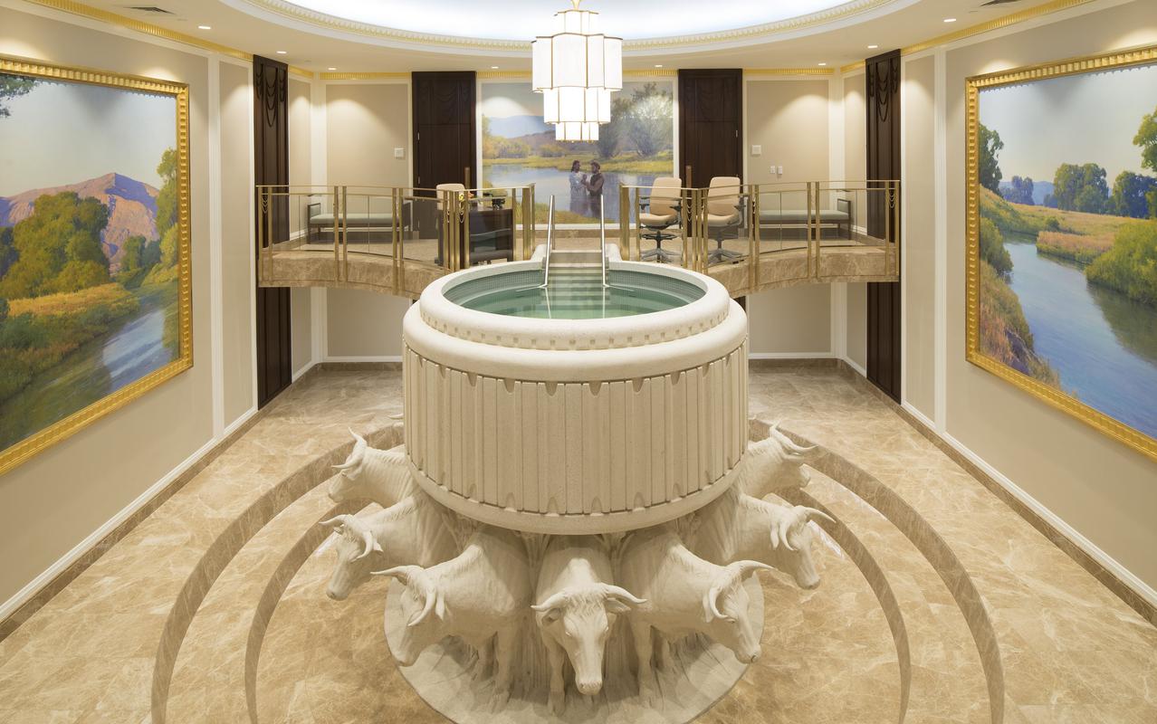 The Jordan River Utah Temple surrounded by lush greenery.