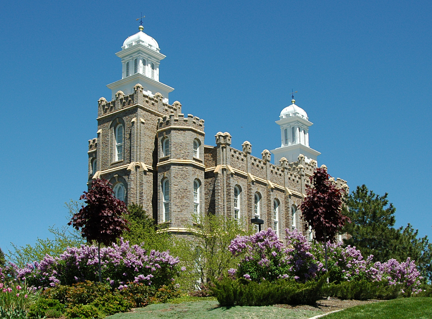 The Logan Temple amid vibrant flower gardens