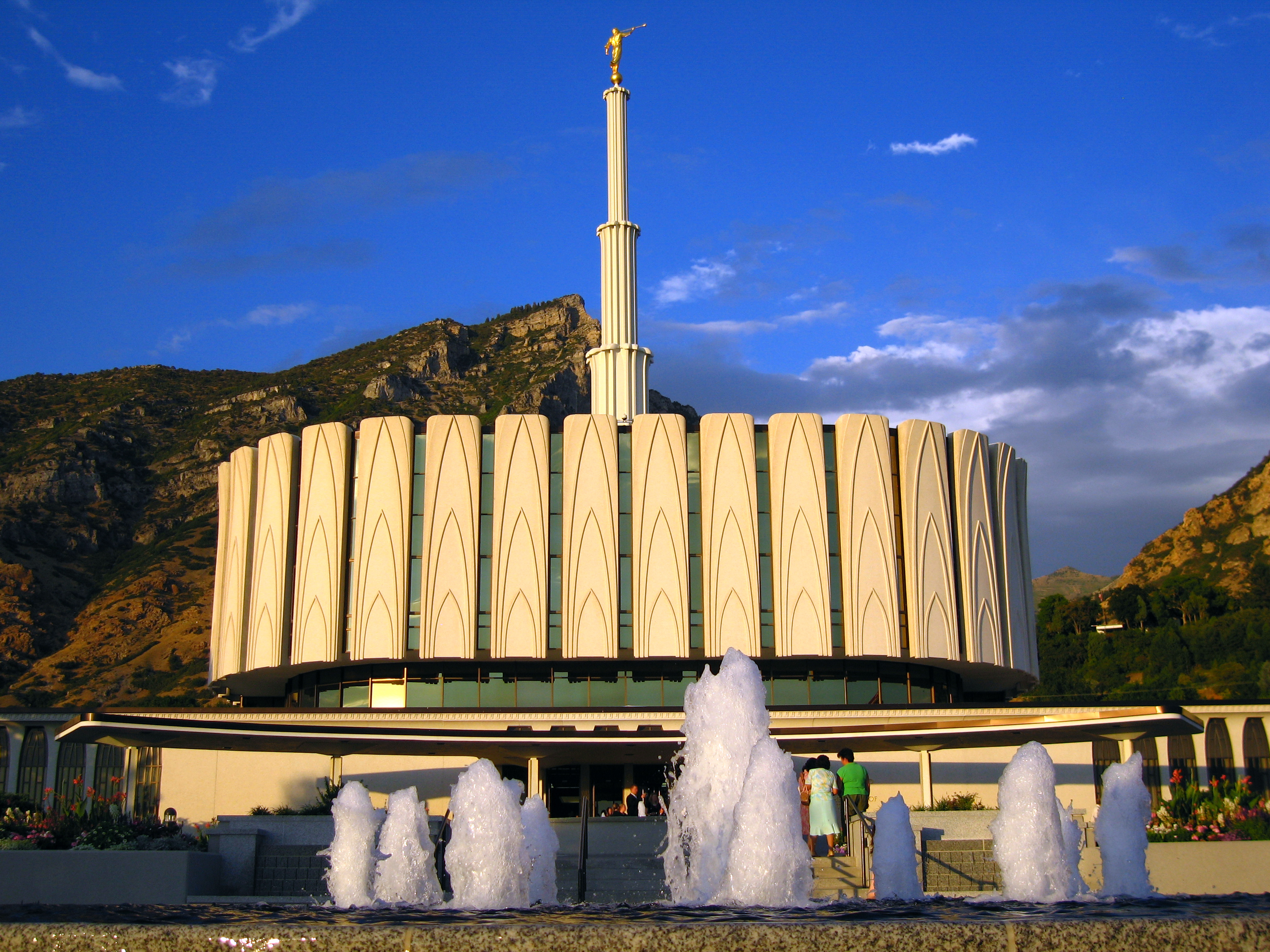 The temple illuminated at night against the mountains